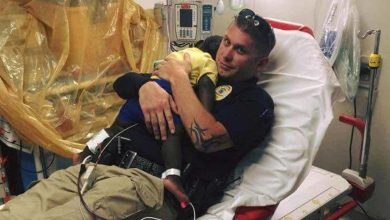 Photo of Picture captures a police officer comforting a scared toddler in the hospital